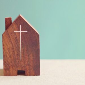 small wooden house with cross